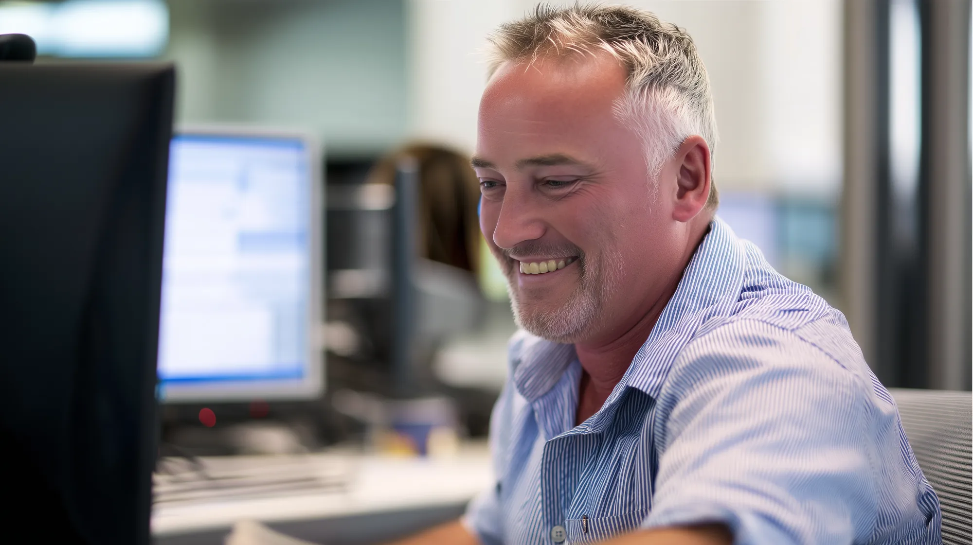 The same operations manager smiling at his screen, the figures already matching
