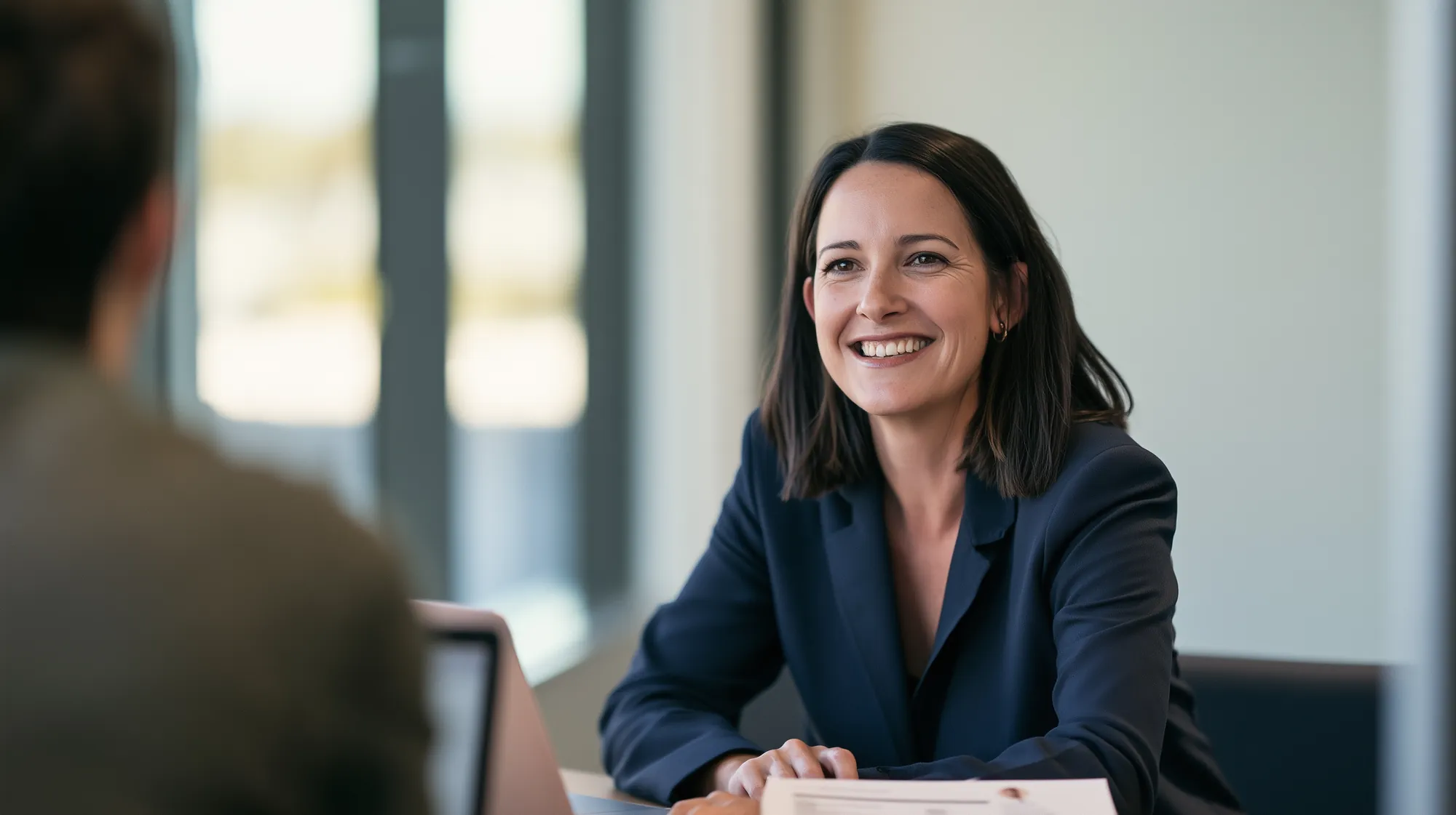 A recruitment consultant talking with a candidate in an office